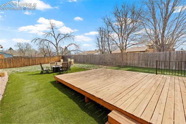 a view of a chairs and table in patio