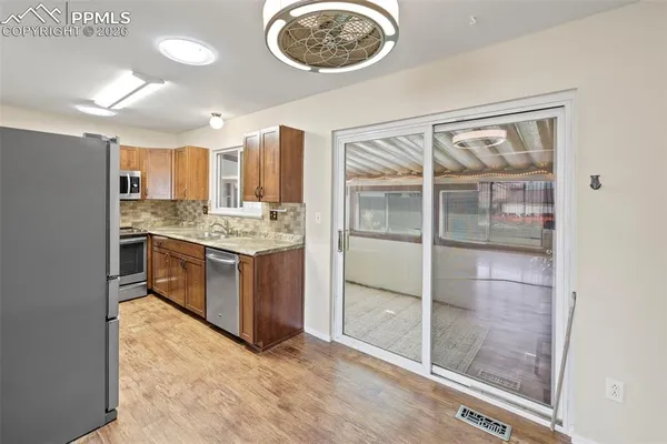 a kitchen with stainless steel appliances granite countertop a stove and a refrigerator