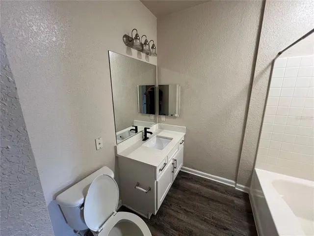 a bathroom with a sink toilet and mirror