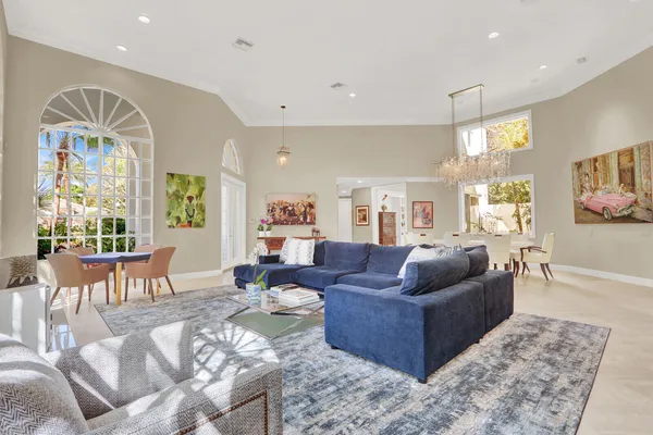 a view of a dining room with furniture and chandelier