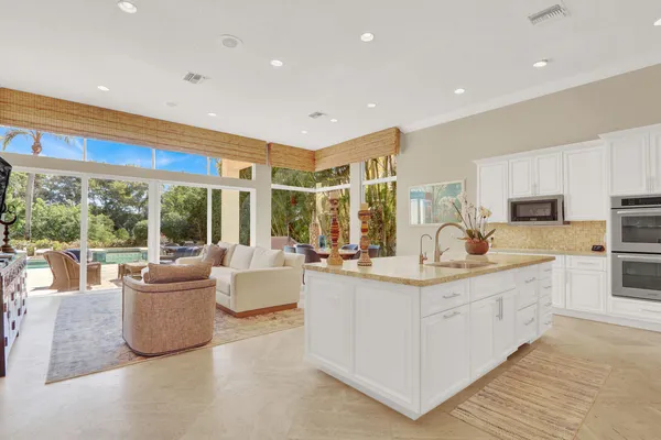 a kitchen with sink dining table and chairs