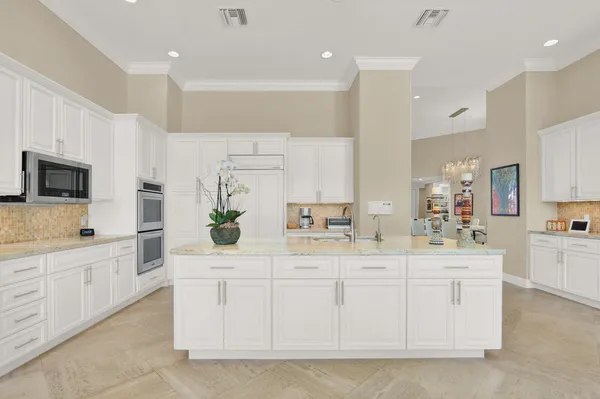 a living room with furniture and large windows