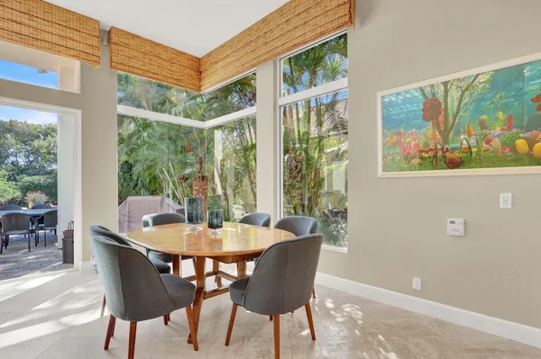 a living room with furniture a flat screen tv and a large window