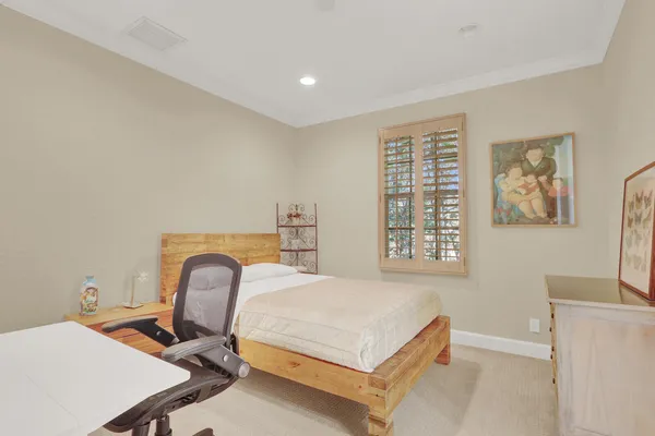a spacious bedroom with a large bed and a couch