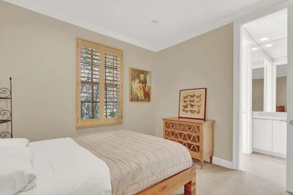 a bedroom with two beds and a window