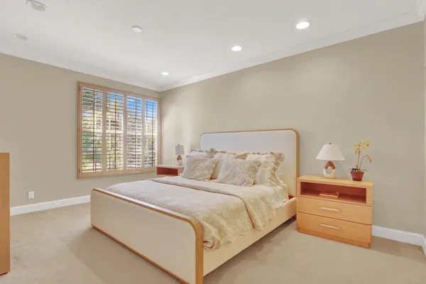 a bedroom with a bed and a window