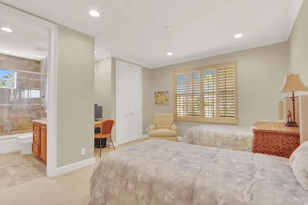 a spacious bedroom with a bed and a large window