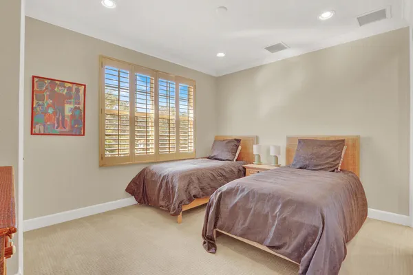 a bedroom with furniture and a flat screen tv