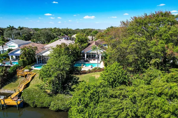 a front view of a house with a yard and a garden