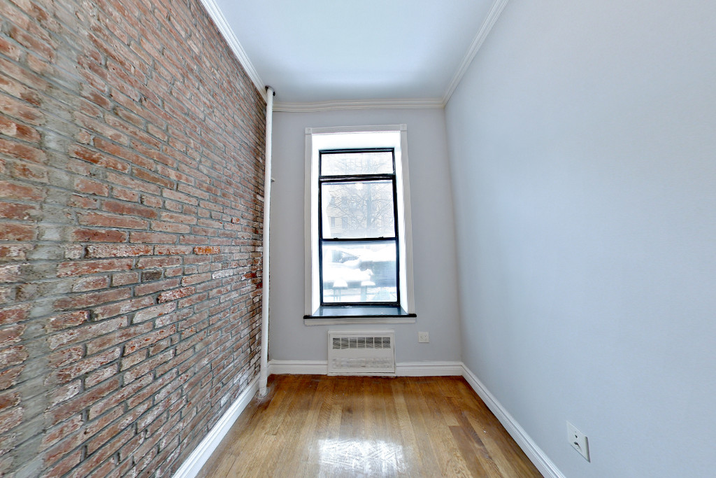 424 West 51st Street, Unit 2 Manhattan, NY 10019 - Photo 5 of 9 a view of empty room with wooden floor and fan