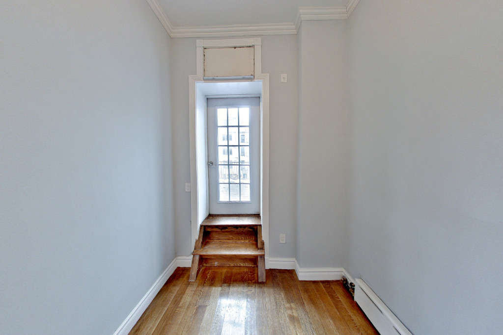 424 West 51st Street, Unit 2 Manhattan, NY 10019 - Photo 8 of 9 a room with wooden floor and a window