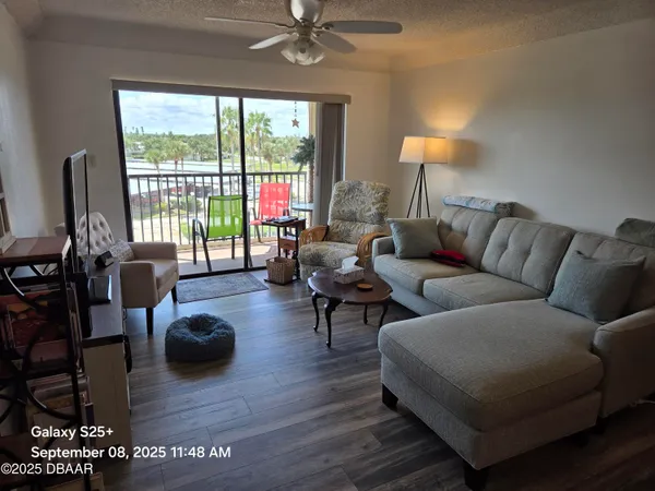 a living room with furniture and wooden floor