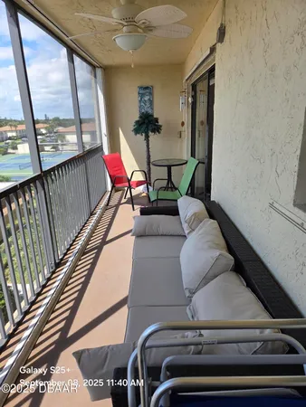 a view of a chairs and table in the balcony