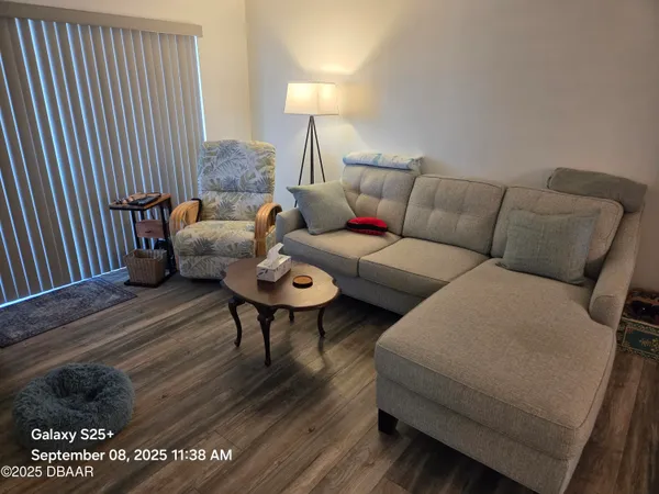 a living room with furniture and a large window