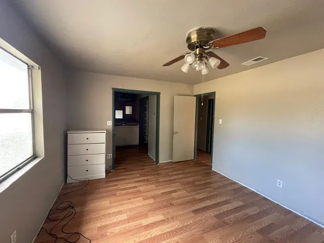 wooden floor in an empty room and a window