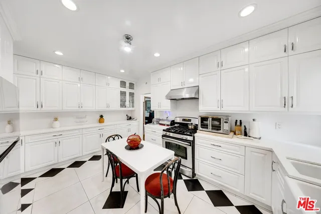 a kitchen with a refrigerator and a stove