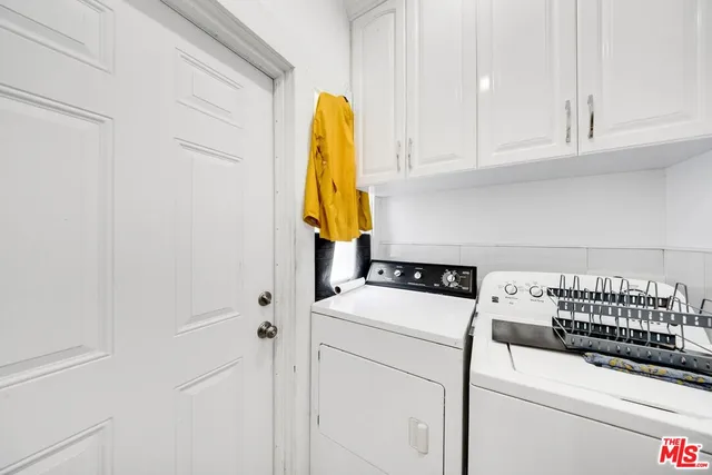 a spacious bathroom with a double vanity sink mirror and shower