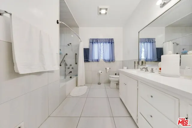 a spacious bedroom with a bed and wooden floor