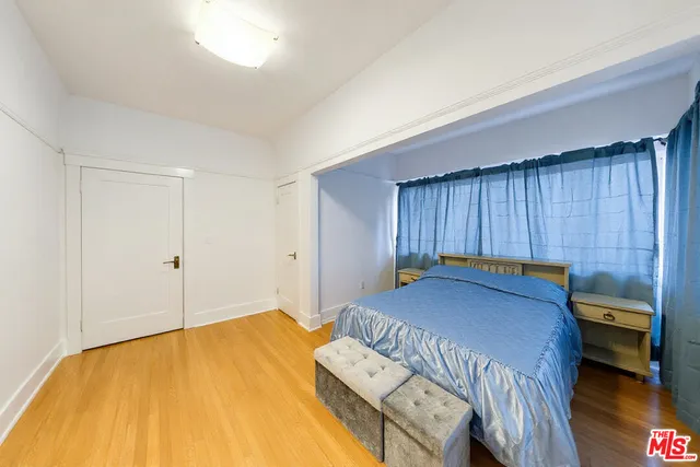 a bedroom with a bed and a dresser