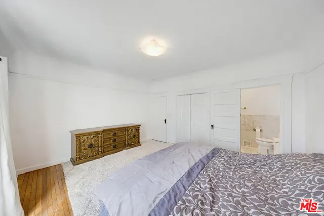 a bedroom with a bed and a night stand