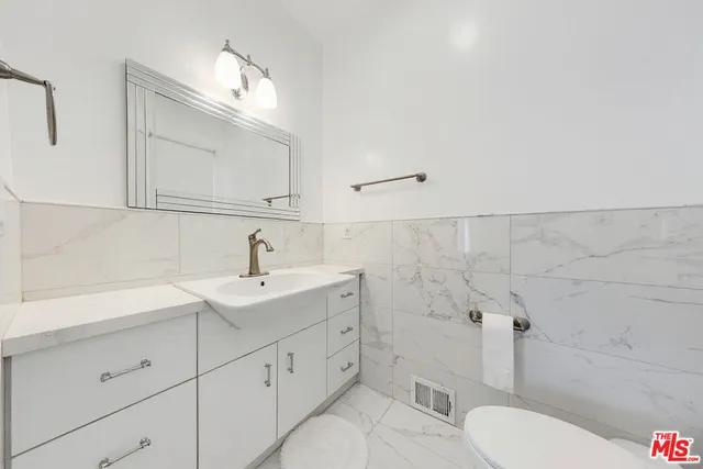 a view of a room with wooden floor and chandelier
