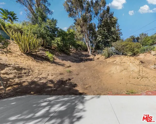 a view of dirt yard with a tree