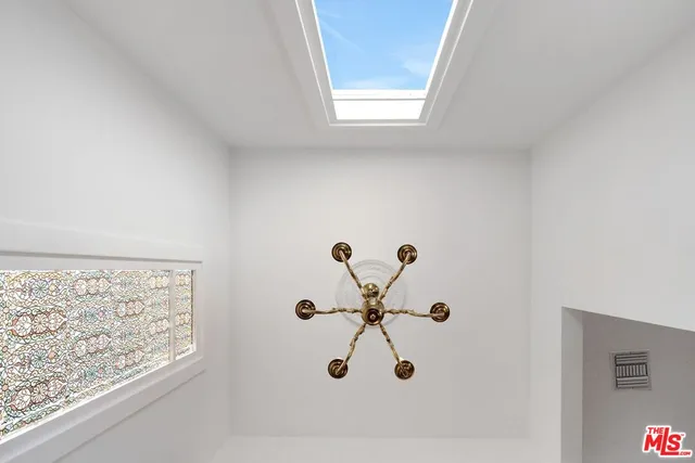 a view of empty room with wooden floor and fireplace