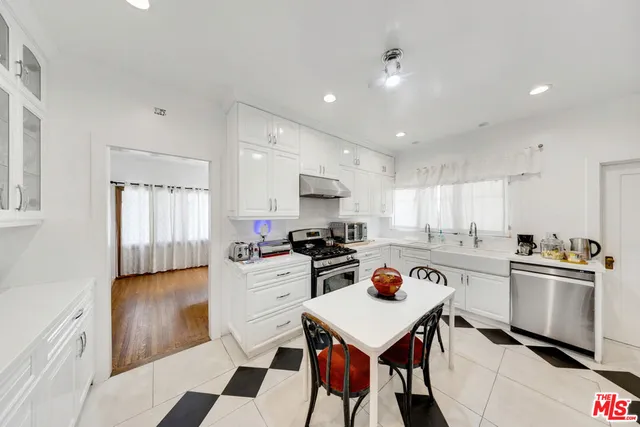 a kitchen with a refrigerator a stove a sink and a stove