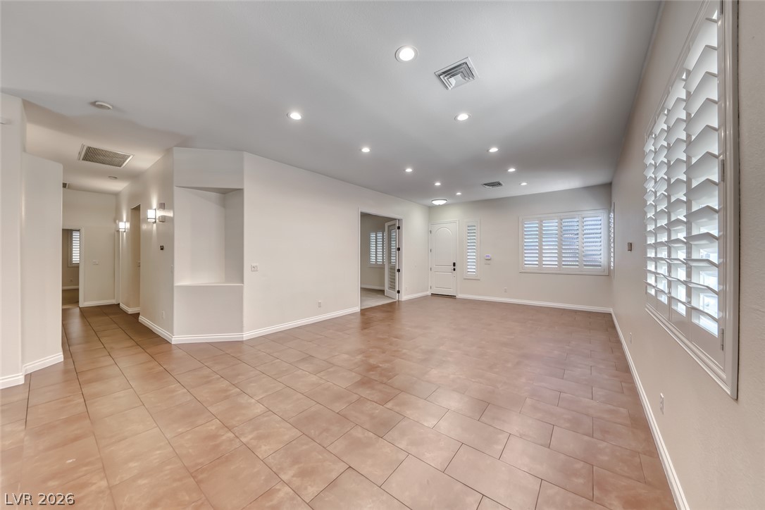 2122 Mooreview Street Henderson, NV 89012 - Photo 5 of 44 Recessed lighting illuminates this versatile interior space with warm, inviting light.