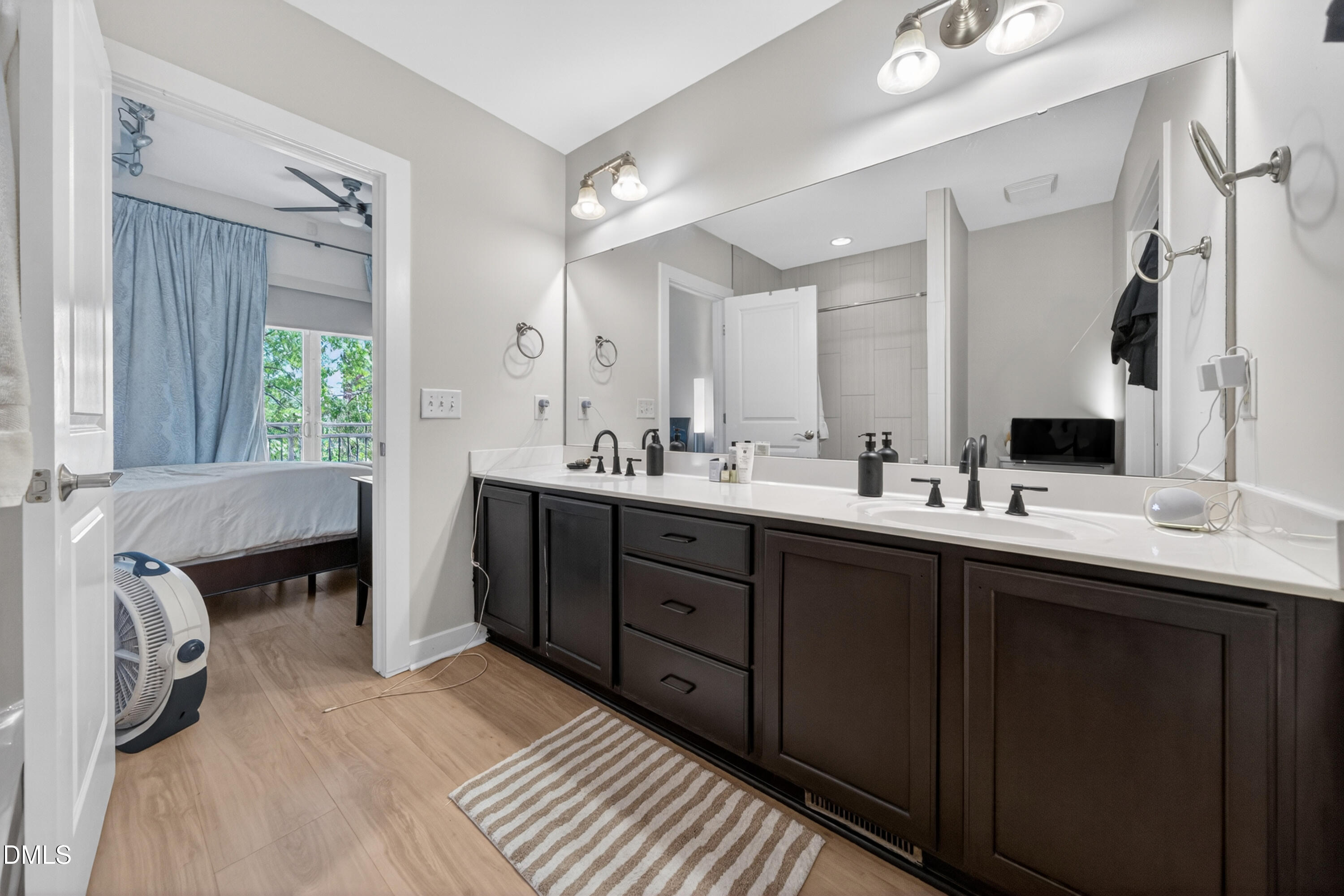 444 South Blount Street, Unit 111 Raleigh, NC 27601 - Photo 37 of 40 a bathroom with a double vanity sink and a mirror