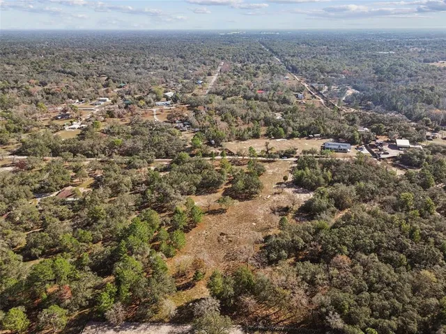 an aerial view of residential houses and outdoor space