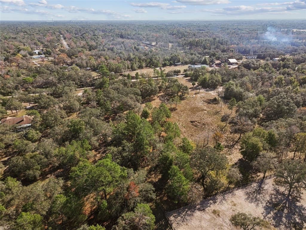 14459 Coyote Road Hudson, FL 34669 - Photo 40 of 55 an aerial view of house with yard and mountain view in back