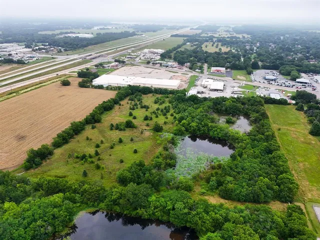 an aerial view of residential houses with outdoor space and river