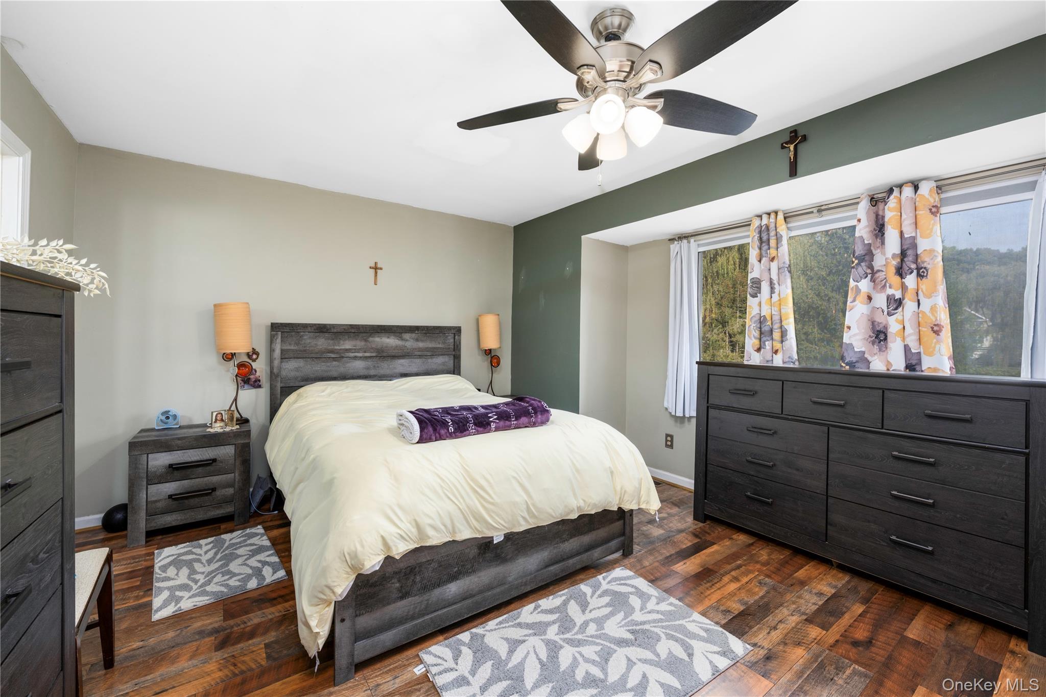 5704 Manor Drive Peekskill, NY 10566 - Photo 12 of 39 a bedroom with a bed and a chandelier