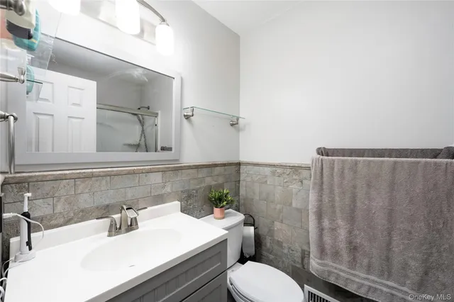 a view of an empty room with wooden floor and window