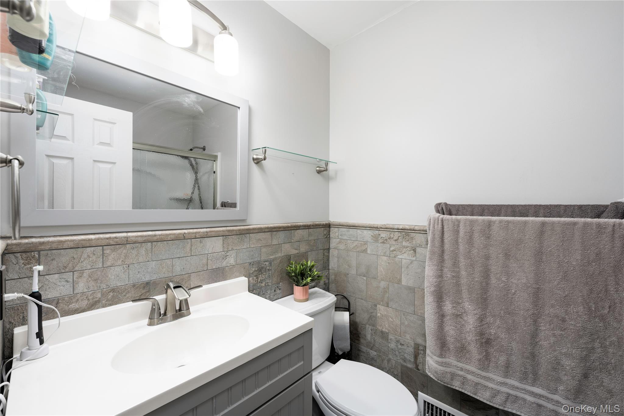 5704 Manor Drive Peekskill, NY 10566 - Photo 14 of 39 a bathroom with a sink toilet and shower