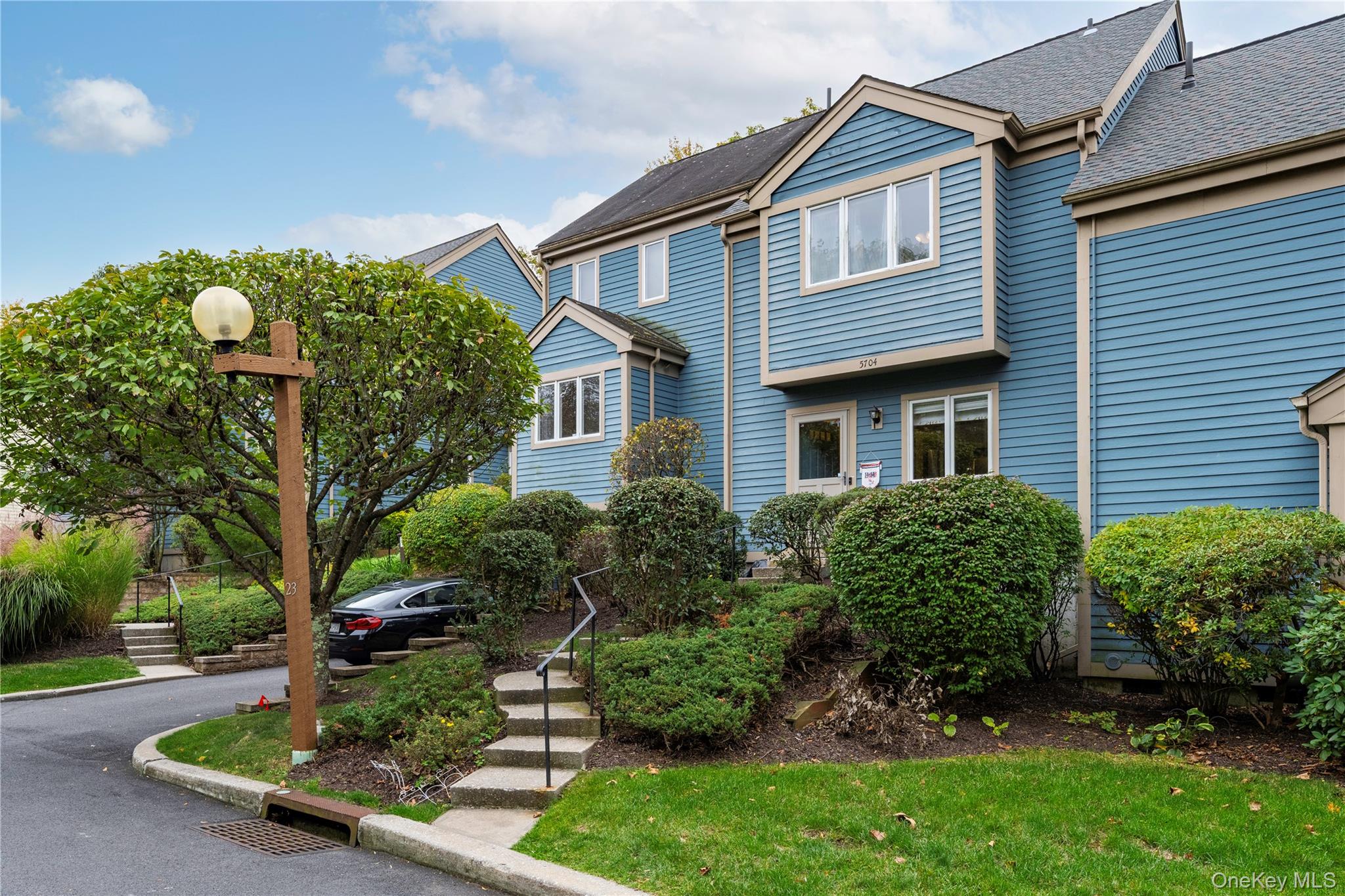 5704 Manor Drive Peekskill, NY 10566 - Photo 2 of 39 a front view of a house with a yard and potted plants