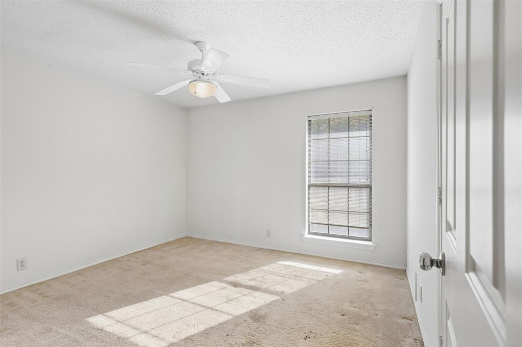 37 Timbergreen Circle Denton, TX 76205 - Photo 23 of 31 Neutral wall paint, carpet flooring, a multi-pane window, and a ceiling fan with integrated lighting