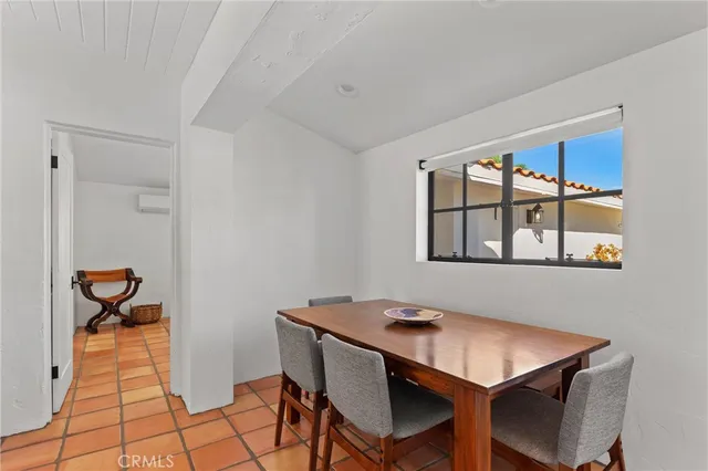 a view of a room that has a table and chairs in it