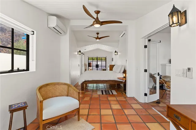 a living room with a patio furniture and a chandelier