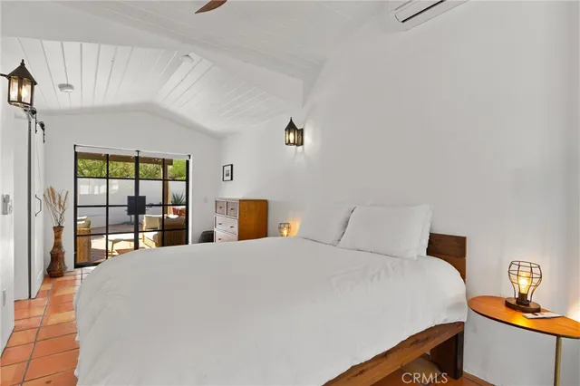 a bedroom with a large bed and a window