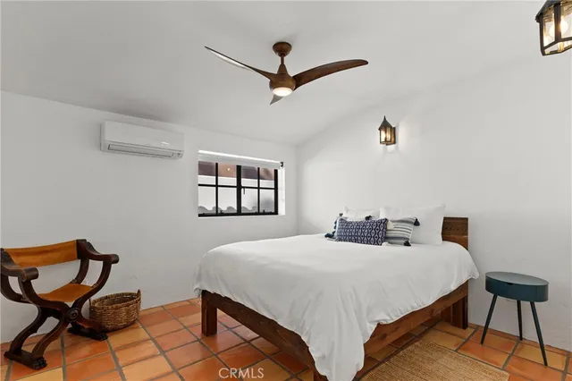 a bedroom with a bed and chair