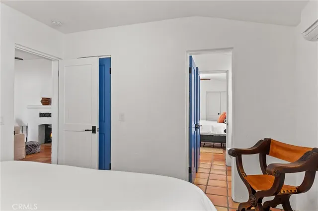 a bedroom with a bed and a chair