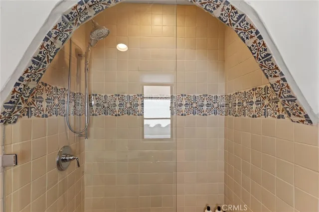 a bathroom with a glass shower door and a shower