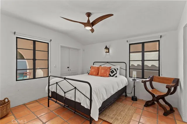 a bedroom with a bed chair and window