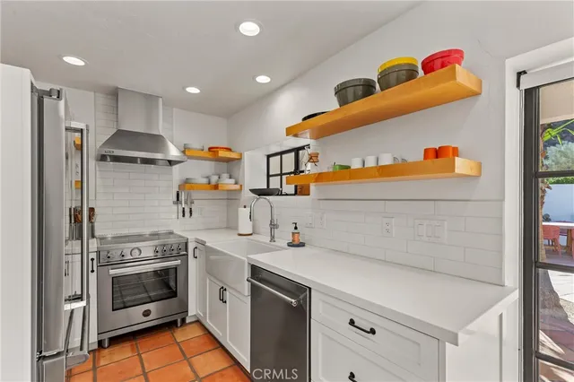 a kitchen with stainless steel appliances granite countertop a stove and a refrigerator