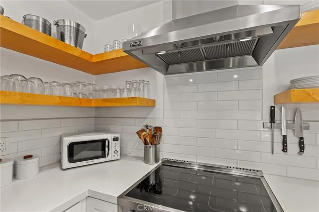 a close view of a sink and a stove in the kitchen