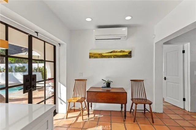a room with furniture and a floor to ceiling window