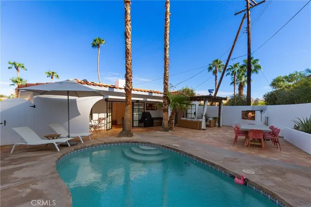 a view of a swimming pool with chairs