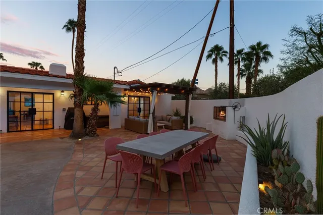 a view of a patio with table and chairs potted plants
